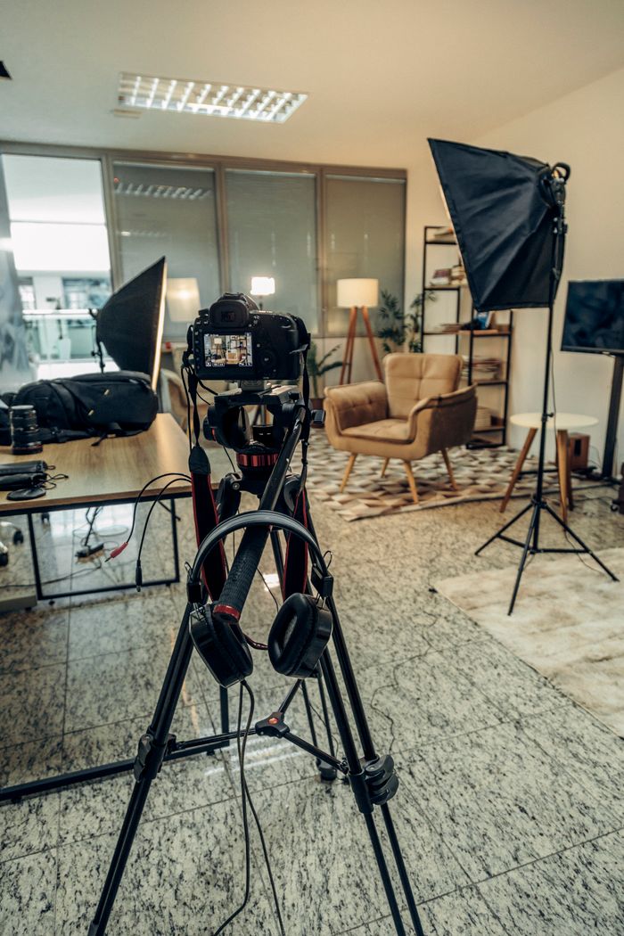 An indoor professional photography studio setup with camera and lighting equipment ready for a photoshoot.